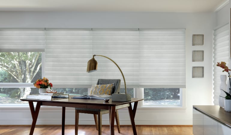 Motorized shades in a home office.